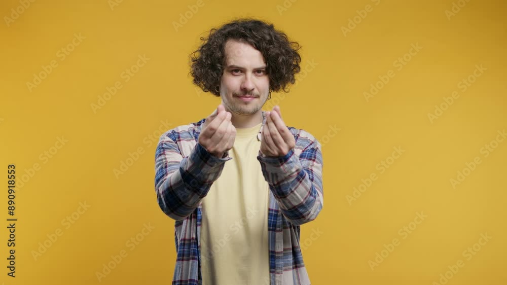 Curly man asking money gesture on yellow studio background. Smart curly dude Curly man asking money gesture on yellow studio background. Smart curly dude