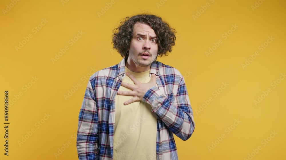 Frightened man on yellow backdrop.Phobia, trouble, panic concept. Scary surprise