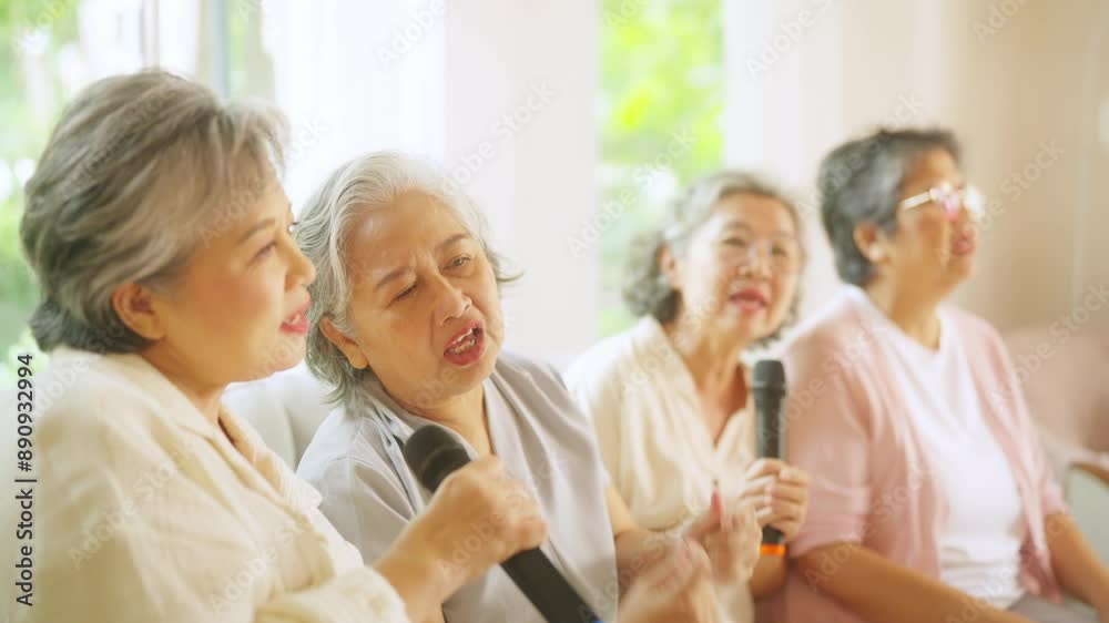 Group of Happy Asian senior women friends singing karaoke with dancing together in living room. Elderly retired people enjoy and fun indoor lifestyle spending time together with home entertainment. Group of Happy Asian senior women friends singing karaoke with dancing together in living room. Elderly retired people enjoy and fun indoor lifestyle spending time together with home entertainment.