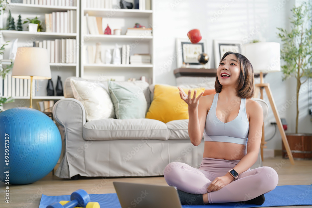 young sporty woman in sportswear sitting on yoga mat in the living room,throw up an apple during fitness training,concept of people lifestyle,workout,health care young sporty woman in sportswear sitting on yoga mat in the living room,throw up an apple during fitness training,concept of people lifestyle,workout,health care