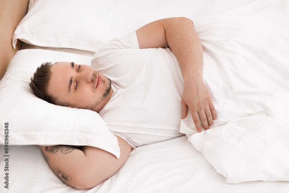 Bedtime. Handsome man sleeping in bed indoors Bedtime. Handsome man sleeping in bed indoors