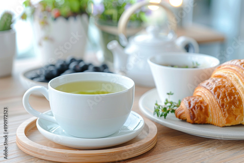 Wallpaper Mural A cup of green tea and croissant on table at hotel restaurant cafe Torontodigital.ca