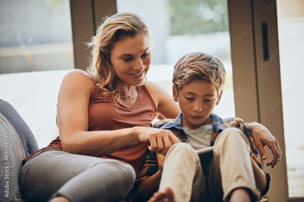 Obraz premium Mother, family and child on tablet and sofa for digital education, playing and bonding at home on school break, Happy woman, mom and boy relax with e learning, teaching and online quiz games or app