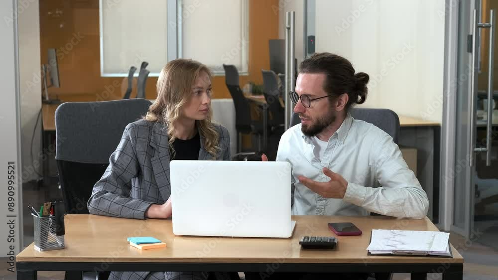 Professionals working together in office. Two businessman busy sharing ideas while looking in one laptop. Camera moving backward. Professionals working together in office. Two businessman busy sharing ideas while looking in one laptop. Camera moving backward.