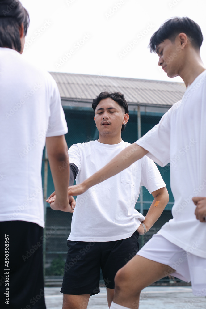 Low Angle View Of Young Soccer Team Stacking Hands At Football Field Low Angle View Of Young Soccer Team Stacking Hands At Football Field