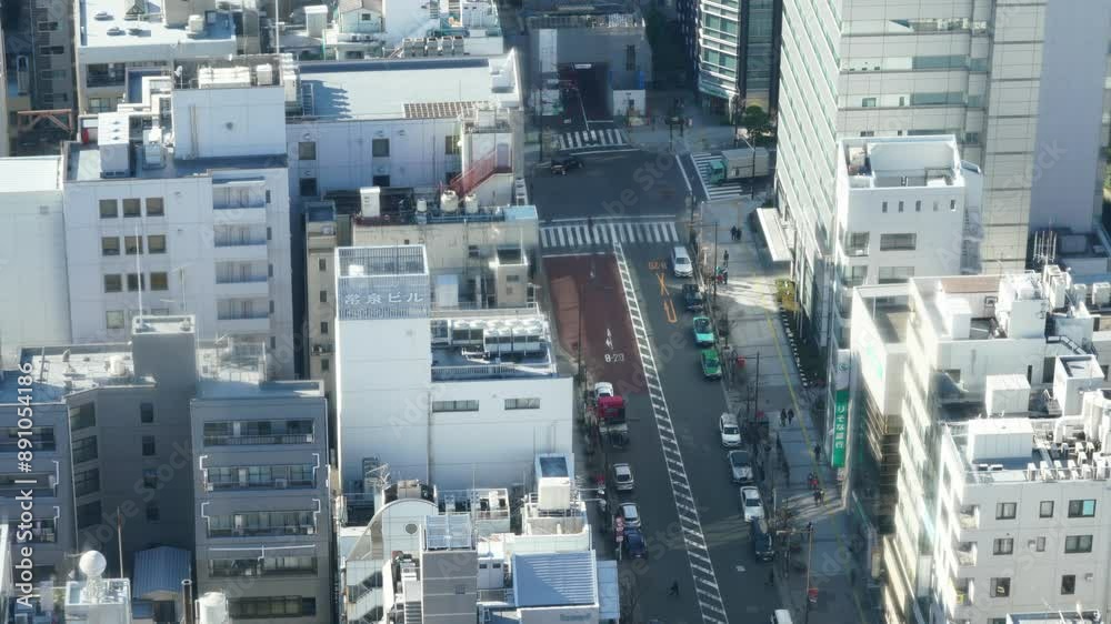 A city street with a large building in the background. The street is crowded with people and cars A city street with a large building in the background. The street is crowded with people and cars