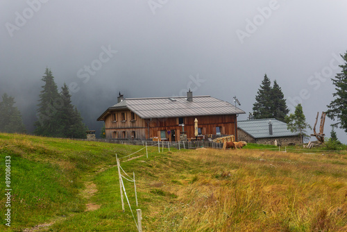 Alpine hut Hochganghaus in the mountains with clouds in Texel group, South Tyrol, Italy photo