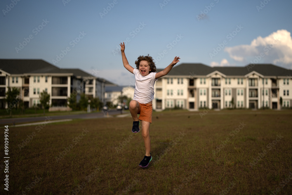 Excited amazed kid boy running on green grass background. Little runners outdoors in summer nature. Sporty child running in a park. Outdoor sports and fitness for children. Excited amazed kid boy running on green grass background. Little runners outdoors in summer nature. Sporty child running in a park. Outdoor sports and fitness for children.