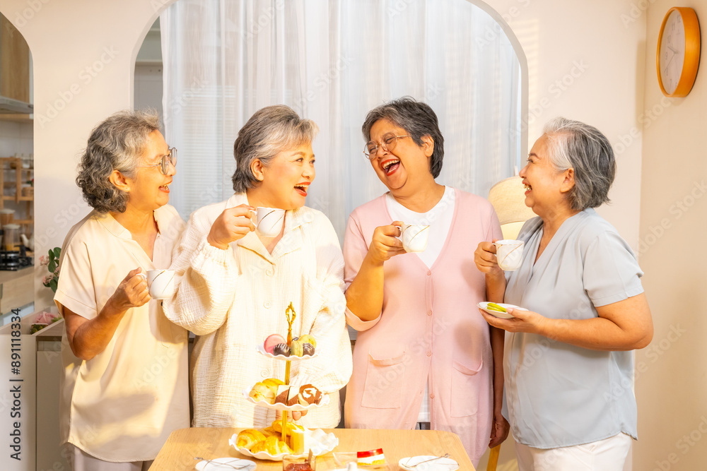 Group of Happy Asian senior women friends having afternoon tea together at home. Elderly retired woman enjoy and fun indoor lifestyle talking together with drinking tea and eating bakery on the table. Group of Happy Asian senior women friends having afternoon tea together at home. Elderly retired woman enjoy and fun indoor lifestyle talking together with drinking tea and eating bakery on the table.