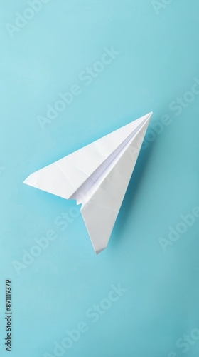 Wallpaper Mural A paper airplane on a blue background, representing simplicity and creativity. The clean and minimalistic composition highlights the playful nature of the paper craft. Torontodigital.ca