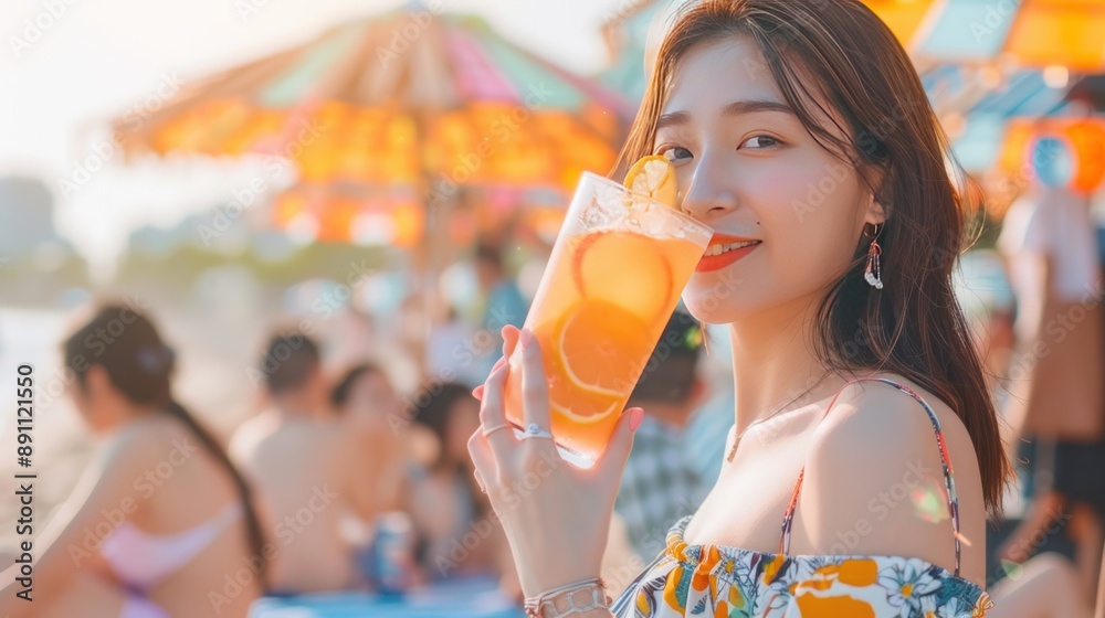 Young Woman Enjoying a Summer Cocktail on the Beach Young Woman Enjoying a Summer Cocktail on the Beach
