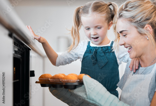 Kitchen, baking and muffins with excited daughter cooking, happy and mother with tray, cupcakes or sweet food. Mama, love and family home fun or woman bonding with child development, support and care