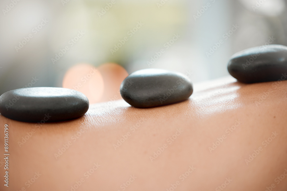 Calm, person and back with hot stone massage at spa for body treatment, wellness and skincare. Resort, hospitality and client with rock for deep tissue healing, holistic and muscle health at hotel Calm, person and back with hot stone massage at spa for body treatment, wellness and skincare. Resort, hospitality and client with rock for deep tissue healing, holistic and muscle health at hotel