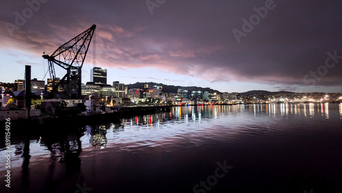 The capital city of Wellington cityscape landscape at night with lights reflective over waterfront harbour in New Zealand Aotearoa  photo