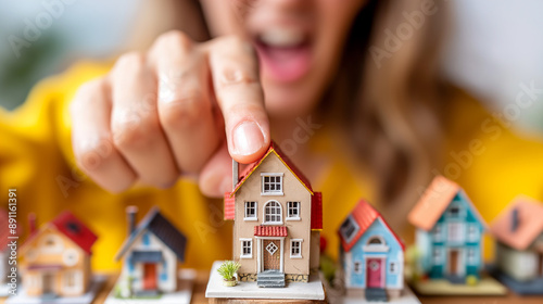 Woman showing with one hand a mini miniature house Real state concept