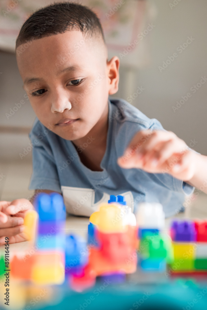 A boy is playing a disassembling game at home A boy is playing a disassembling game at home