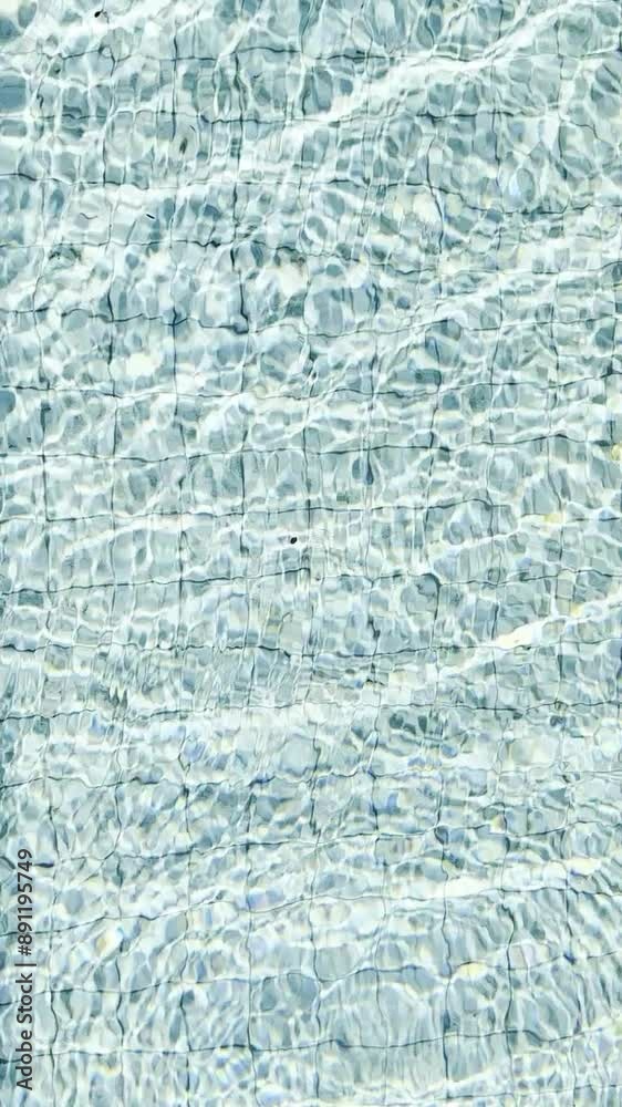 Sunlit ripples on clear swimming pool water
Sunlit ripples on clear swimming pool water