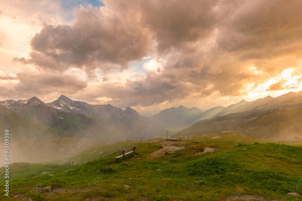 Golden Alpine Sunset with Yellow Wildflowers and a Solitary Bench Golden Alpine Sunset with Yellow Wildflowers and a Solitary Bench