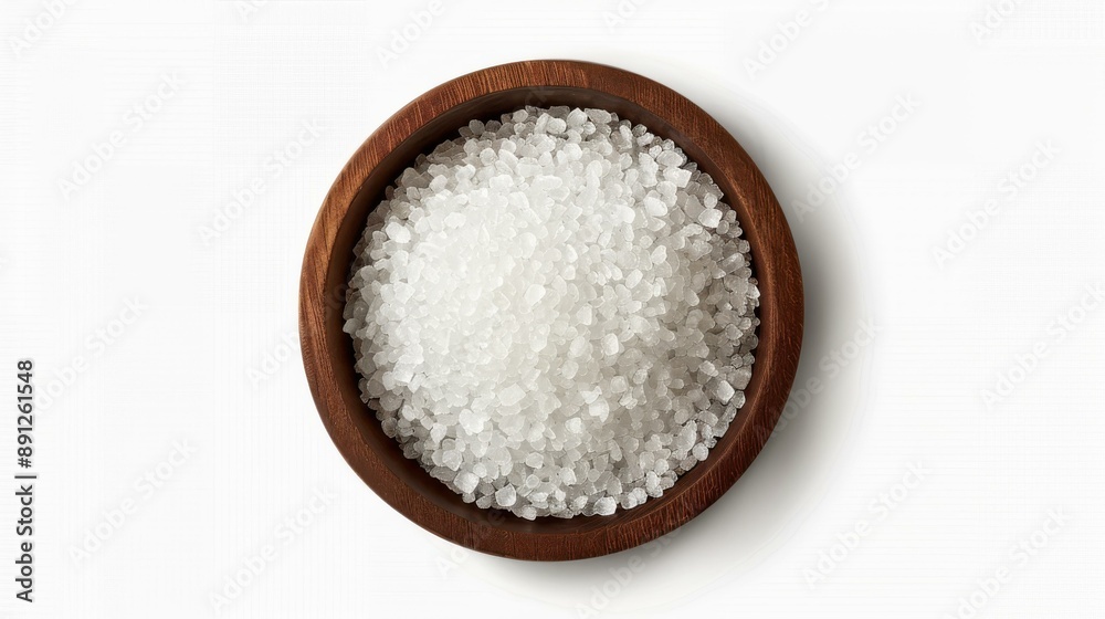 Top view of sea salt in a rustic wooden bowl on white background. Simple and elegant food styling. Top view of sea salt in a rustic wooden bowl on white background. Simple and elegant food styling.