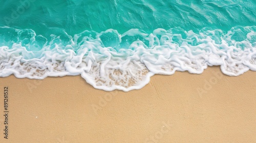 Fototapeta Naklejka Na Ścianę i Meble -  Serene top view of sand beach and sea waves, ideal for summer vacation and travel concepts.