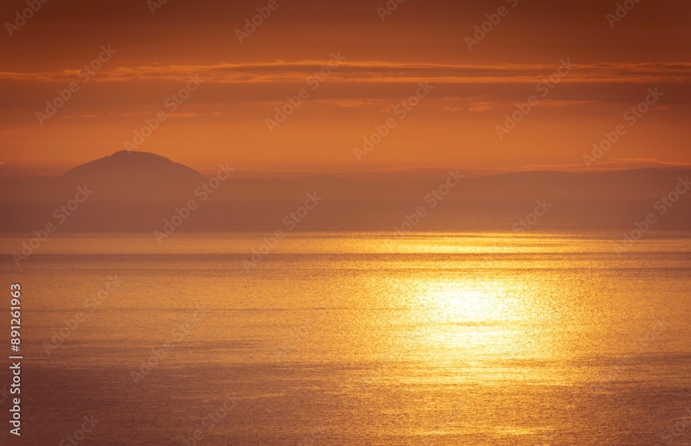 Ailsa Craig at sunrise from the Antrim Coast in County Antrim, Northern Ireland Ailsa Craig at sunrise from the Antrim Coast in County Antrim, Northern Ireland