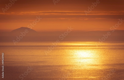 Ailsa Craig at sunrise from the Antrim Coast in County Antrim, Northern Ireland  photo