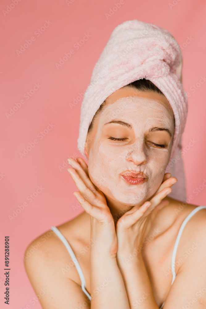 A young girl using products in spa in her bathroom putting a mask on her face blowing a kiss and looking happy and gorgeous A young girl using products in spa in her bathroom putting a mask on her face blowing a kiss and looking happy and gorgeous