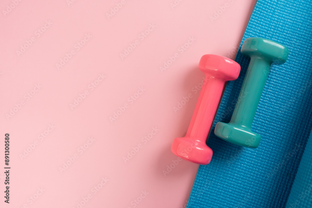 dumbbell and blue yoga mat on table, fitness healthy and sport concept dumbbell and blue yoga mat on table, fitness healthy and sport concept