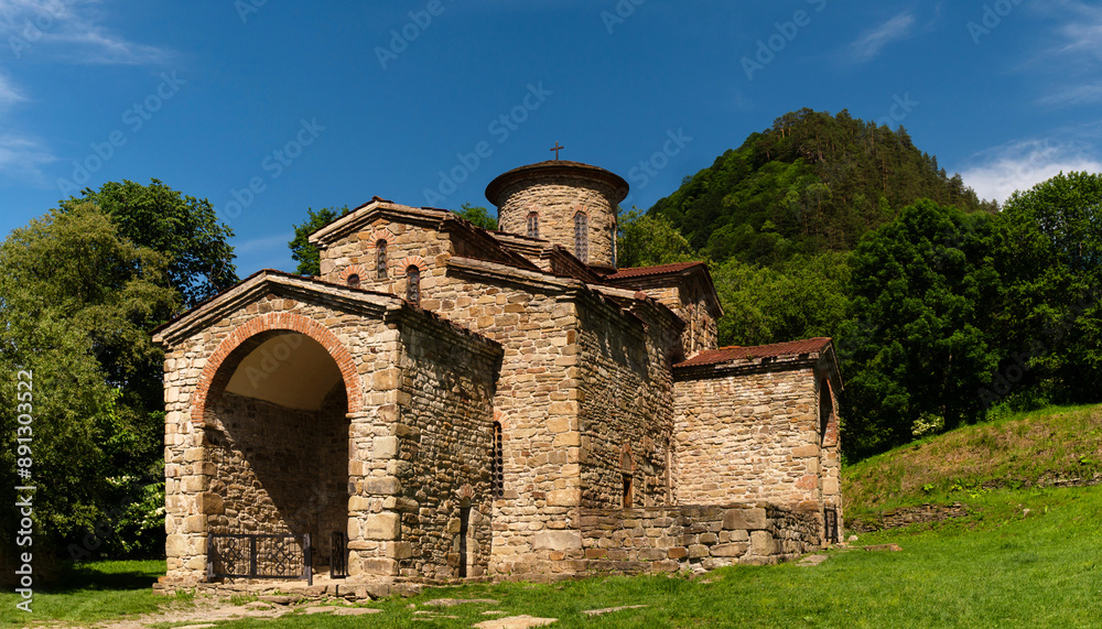 Ancient stone church set in green valley Ancient stone church set in green valley
