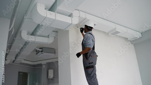 Wallpaper Mural African American HVAC Technician Worker Testing Newly Installed Warehouse Ventilation System Torontodigital.ca