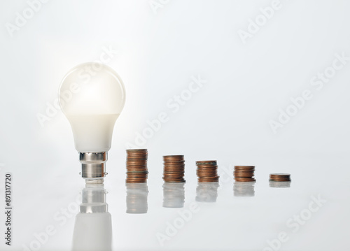 Lightbulb, coins and finance with savings for accounting ideas, problem solving and cash innovation of bankruptcy. Money, financial budget and bank value for security, solution and cost reduction