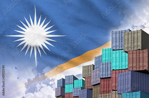 Marshall Islands flag and big stack of shipping cargo containers in docks with sky background close up photo