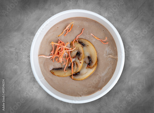 Cream soup of porcini mushrooms. Healthy food. Takeaway food. Top view, on a gray background. photo