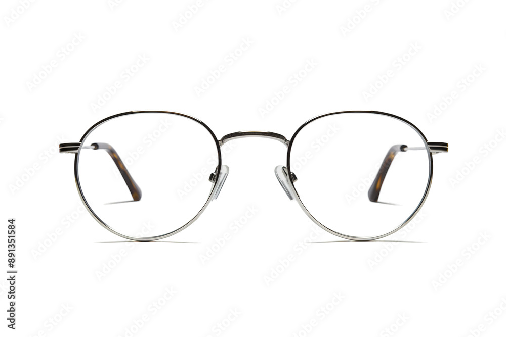 A Pair of Sleek, Silver-Rimmed Round Glasses Resting on a White Background on a Clear PNG or White Background. A Pair of Sleek, Silver-Rimmed Round Glasses Resting on a White Background on a Clear PNG or White Background.
