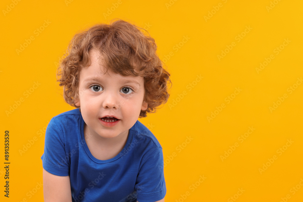 Portrait of cute little boy on yellow background, space for text Portrait of cute little boy on yellow background, space for text