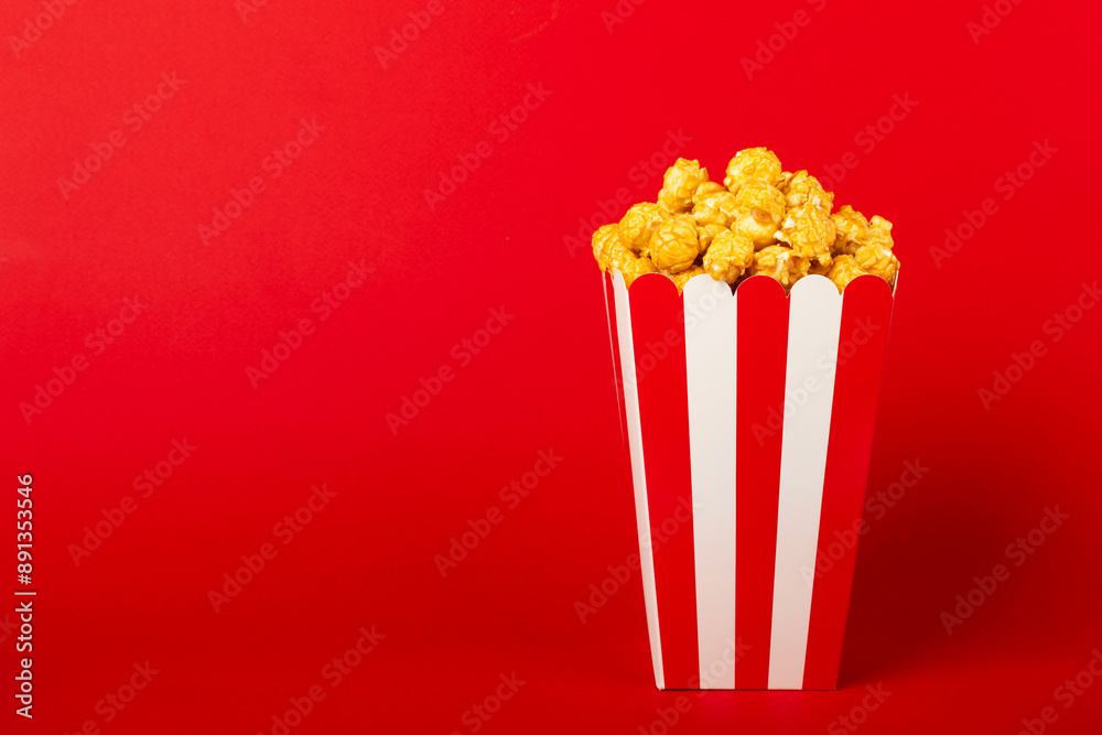 Bucket of sweet caramel popcorn on a wooden background. Salted caramel popcorn. Caramel sauce. Close up. Topping. Place for text. Copy space Bucket of sweet caramel popcorn on a wooden background. Salted caramel popcorn. Caramel sauce. Close up. Topping. Place for text. Copy space