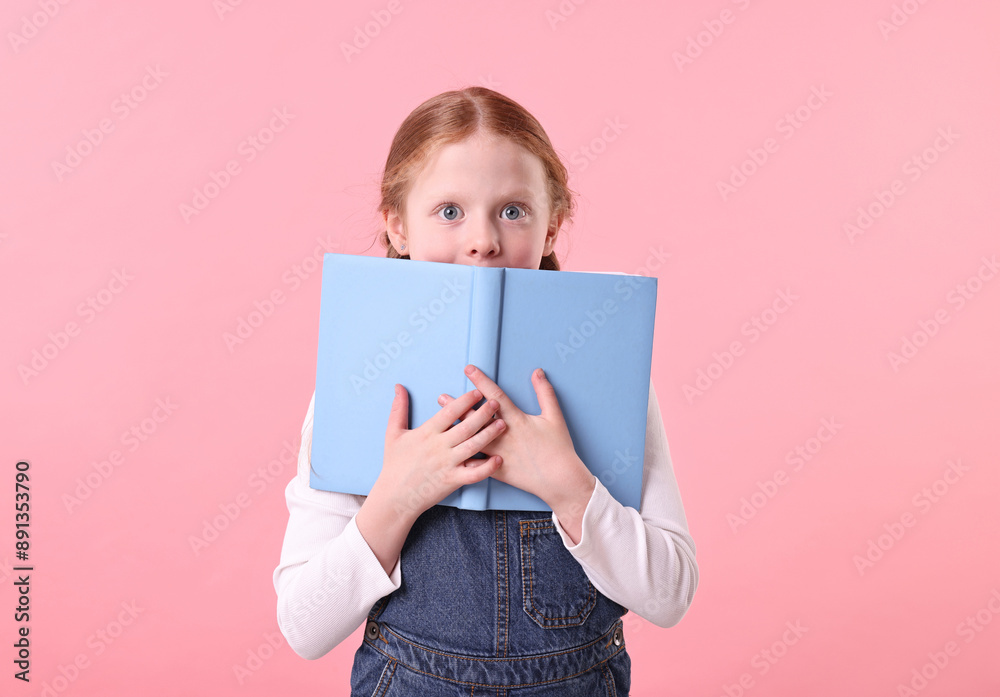 Cute little girl with books on pink background Cute little girl with books on pink background
