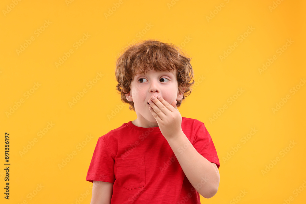 Portrait of emotional little boy on orange background Portrait of emotional little boy on orange background