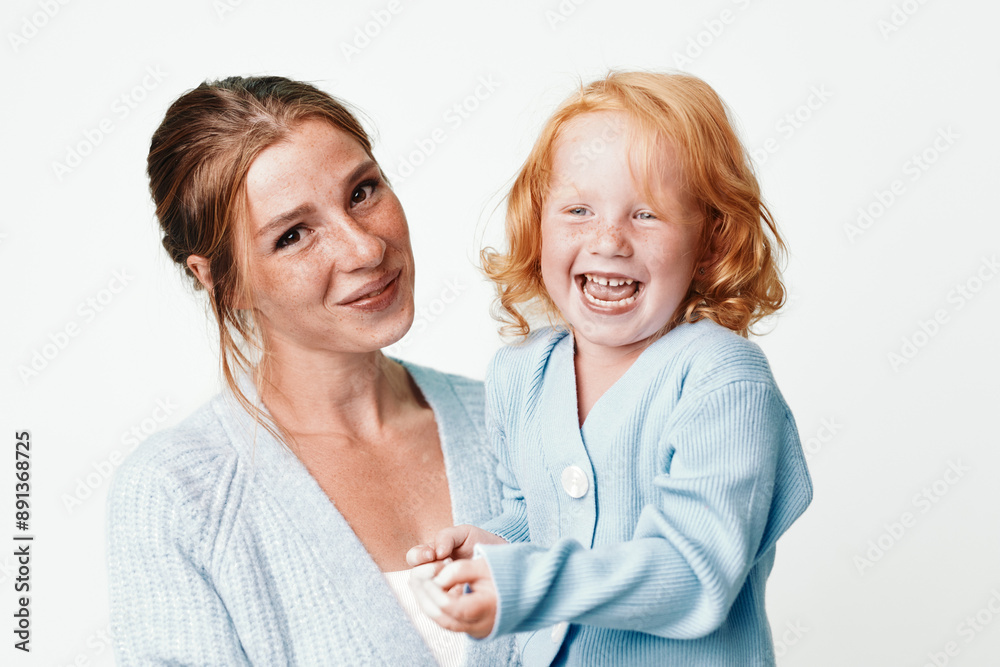 Happy family moments mother and daughter smiling together in front of white background Happy family moments mother and daughter smiling together in front of white background