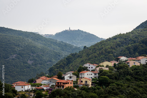 View of the village of Rabac on the Istrian coast of Croatia with the mountains and the town of Labin in the background photo