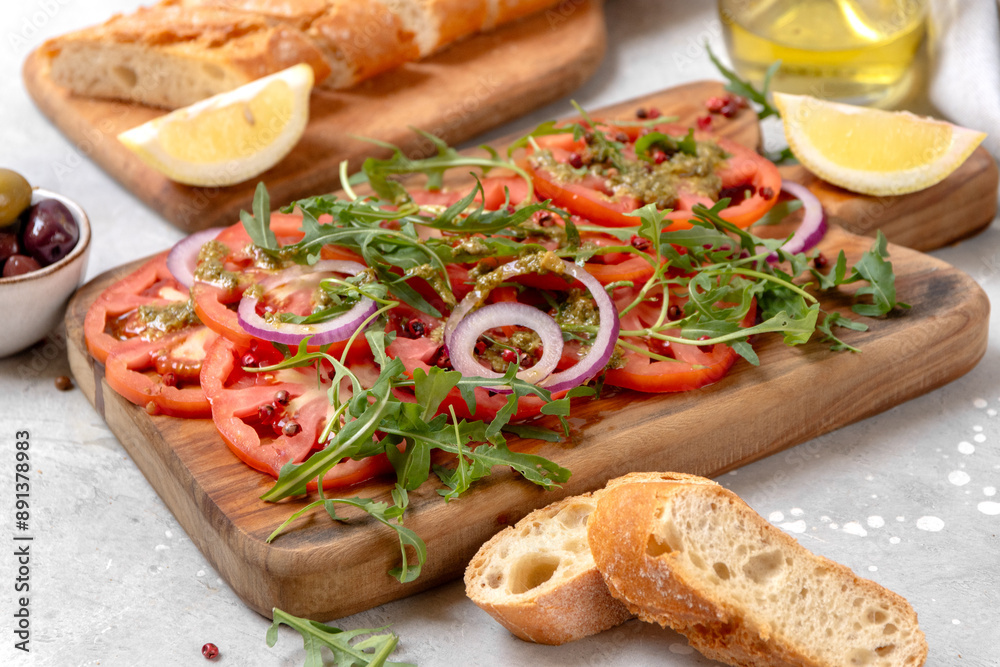 Tomatoes salad Organic tomatoes carpaccio with pesto sauce and arugula, an on-trend summer healthy eating salad Tomatoes salad Organic tomatoes carpaccio with pesto sauce and arugula, an on-trend summer healthy eating salad
