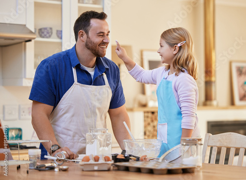 Playing, baking and dad with child in kitchen with ingredients for bonding, learning and fun together. Family, home and happy father and girl help with recipe for cupcake, dessert and sweet treats