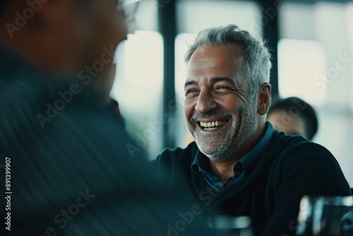 Senior businessman smiling during a meeting with his partners