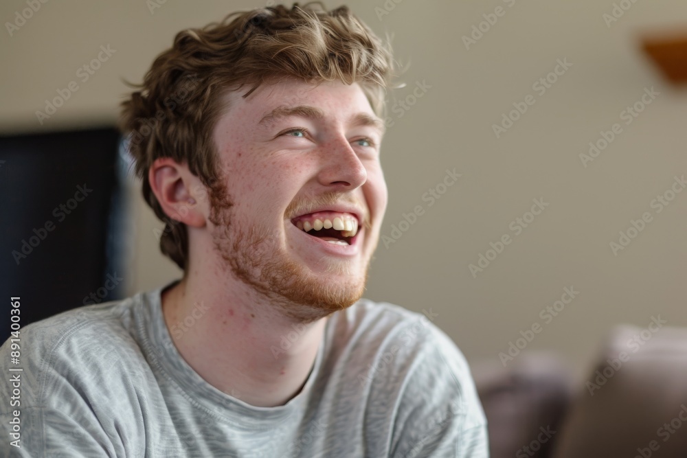 Obraz premium Young man is laughing out loud at home