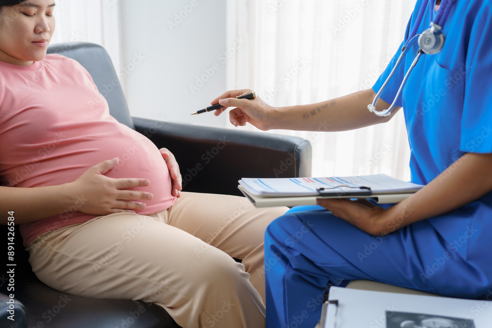 Pregnant mothers meet the nurse at the clinic as scheduled, reviewing their medical history and discussing symptoms. Sitting on the sofa, they report headaches, nausea, and back pain to the nurse. Pregnant mothers meet the nurse at the clinic as scheduled, reviewing their medical history and discussing symptoms. Sitting on the sofa, they report headaches, nausea, and back pain to the nurse.