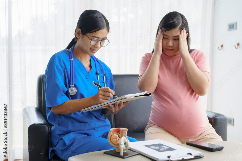Obraz premium Pregnant mothers meet the nurse at the clinic as scheduled, reviewing their medical history and discussing symptoms. Sitting on the sofa, they report headaches, nausea, and back pain to the nurse.