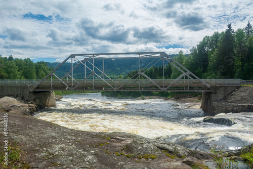 old metal bridge over the wild Heddola river, Norway . photo