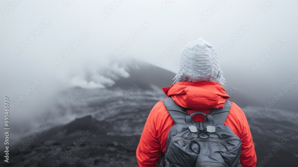 A person wearing an orange jacket and gray backpack is hiking towards a volcanic area surrounded by mist and steam, creating a dramatic and adventurous atmosphere. A person wearing an orange jacket and gray backpack is hiking towards a volcanic area surrounded by mist and steam, creating a dramatic and adventurous atmosphere.