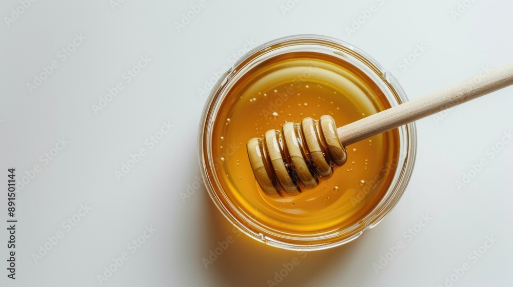 Honey in glass jar with wooden spoon isolated on white background Honey in glass jar with wooden spoon isolated on white background