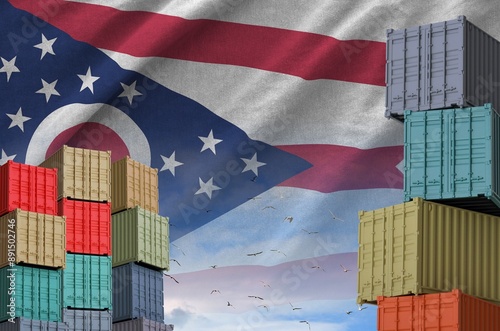 Ohio US state flag and big stack of shipping cargo containers in docks with sky background close up photo